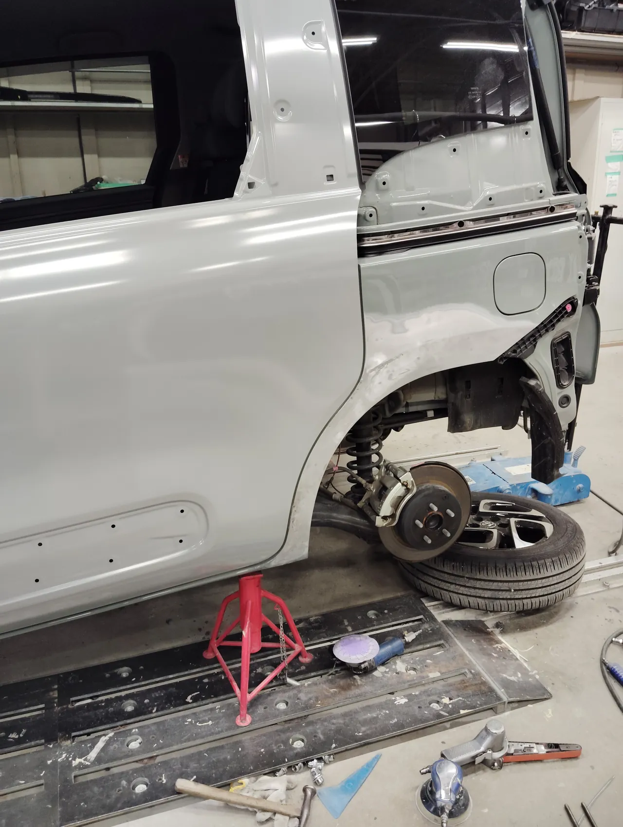 塗る前の交換用の左スライドドア(ガラス・ハンドルなし)を車体に付けたシエンタ。左リヤクォーターの前の下を研いで鉄板を出したところ
