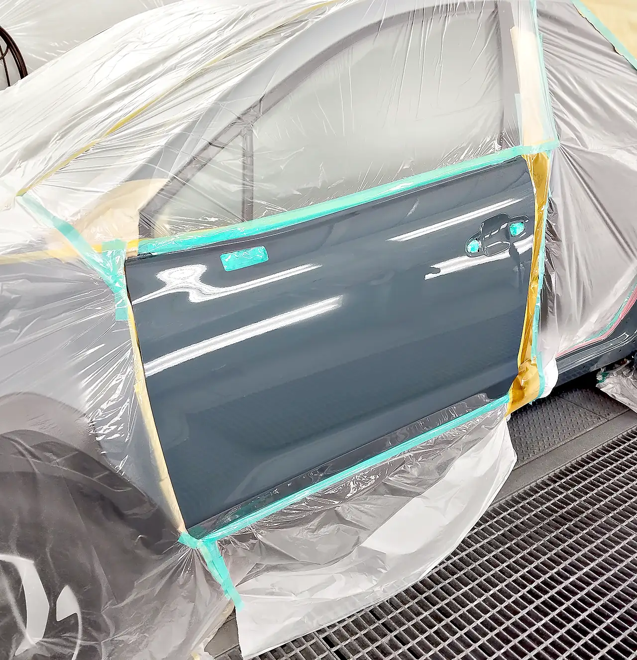車に付けたまま塗り終えたクロストレックの左フロントドア。ブースの照明が映り込む（塗装後）